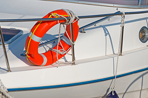 Orange life buoy on a white boat